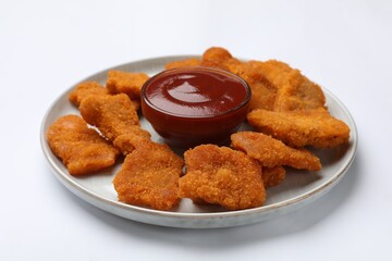 Delicious chicken nuggets with ketchup on white background