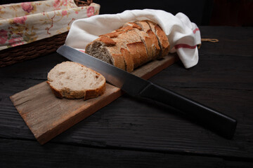 Rustic Bread Display with Sliced Whole Grain Loaf in Wicker Basket on Wooden Table - Perfect for Bakery, Culinary, and Farmhouse Decor Themes