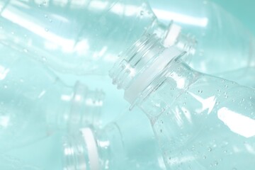 Many plastic bottles on light background, closeup
