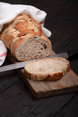Rustic Bread Display with Sliced Whole Grain Loaf in Wicker Basket on Wooden Table - Perfect for Bakery, Culinary, and Farmhouse Decor Themes