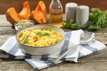 Delicious pumpkin risotto served on wooden table