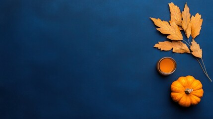 Autumn Harvest: Pumpkins and Maple Leaves on Dark Blue Background for Thanksgiving Day X Banner with Copy Space
