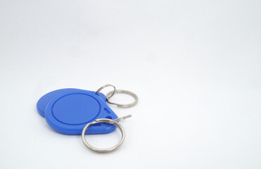 2 blue RFID (Radio Frequency Identification) keychain receivers on white background. Used by electronics, mechatronics, and networking engineers.