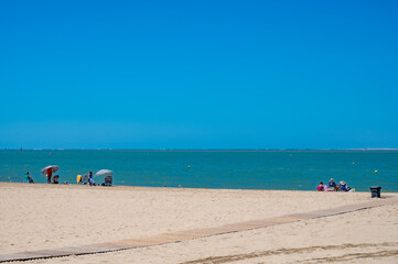 Golden sandy beaches and promenade of Qudalquivir river in Sanlucar de Barrameda, Andalusian town, Spain in summer