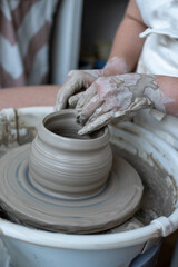Making of mud pot on potters wheel during workshop in art ceramic atelier in Poland