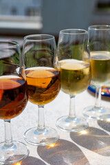 Sherry fino, manzanilla, cream wine tasting on roof of old Triana district in Sevilla with view on Sevilla houses and churches, wine glasses