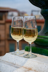 Sherry fino wine tasting on roof of old Triana district in Sevilla with view on Sevilla houses and churches, wine glasses