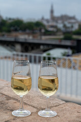 Sherry fino wine tasting on roof of old Triana district in Sevilla with view on Sevilla houses and churches, wine glasses