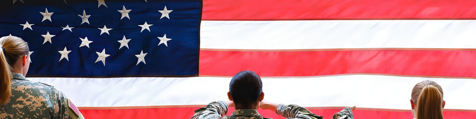 Fototapeta premium Female national guard members raising the American flag during a ceremony.