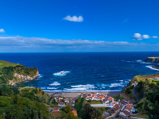 Naklejka premium Praia dos Moinhos. Aerial drone view of volcanic black sand beach in Moinhos town, Sao Miguel, Azores, Portugal. Atlantic ocean coast