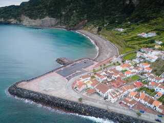 Aerial drone view of Ribeira Quente and Praia do Fogo with volcanic black sand beach. Landscape of Sao Miguel coastline with green mountains in Azores