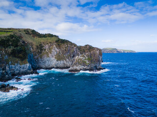 Azores islands coast landscape aerial drone view. Praia dos Moinhos in Sao Miguel island, Portugal. Atlantic ocean shore with cliffs