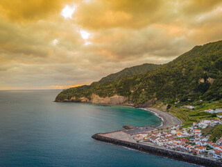 Fototapeta premium Aerial drone view of sunset over Azores islands. Ribeira Quente and Praia do Fogo. Landscape of Sao Miguel coastline with green mountains in Azores