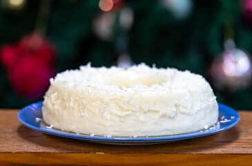 Traditional Brazilian coconut flan dessert known as manjar branco, manjar de coco and manjar dos deuses. Served with plum syrup.