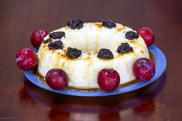 Traditional Brazilian coconut flan dessert known as manjar branco, manjar de coco and manjar dos deuses. Served with plum syrup.
