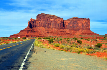 Monument Valley is a region of the Colorado Plateau characterized by a cluster of vast sandstone buttes above the valley floor. It is located on the Arizona-Utah state line, USA