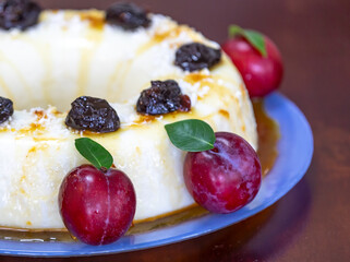 Traditional Brazilian coconut flan dessert known as manjar branco, manjar de coco and manjar dos deuses. Served with plum syrup.