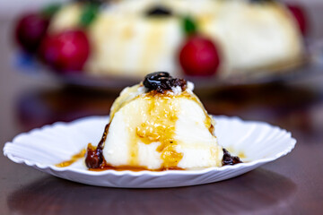 Traditional Brazilian coconut flan dessert known as manjar branco, manjar de coco and manjar dos deuses. Served with plum syrup.