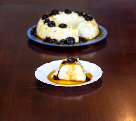 Traditional Brazilian coconut flan dessert known as manjar branco, manjar de coco and manjar dos deuses. Served with plum syrup.