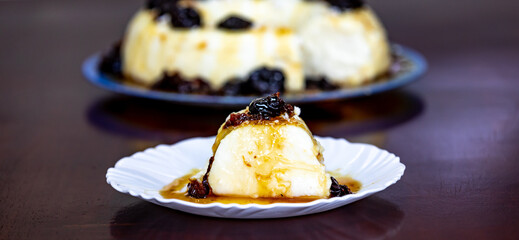 Traditional Brazilian coconut flan dessert known as manjar branco, manjar de coco and manjar dos deuses. Served with plum syrup.
