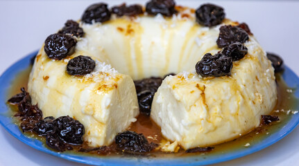 Traditional Brazilian coconut flan dessert known as manjar branco, manjar de coco and manjar dos deuses. Served with plum syrup.