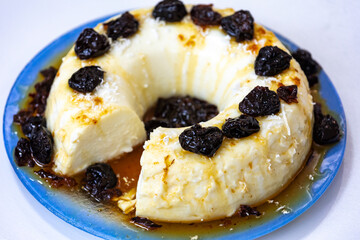 Traditional Brazilian coconut flan dessert known as manjar branco, manjar de coco and manjar dos deuses. Served with plum syrup.