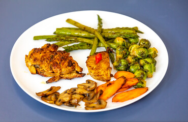 Real, strong, healthy, nutritious food, grilled chicken, pimenta biquinho, asparagus, mushrooms, Brussels sprouts and carrots.
