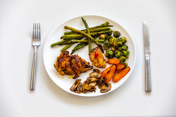Real, strong, healthy, nutritious food, grilled chicken, pimenta biquinho, asparagus, mushrooms, Brussels sprouts and carrots.