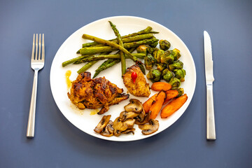 Real, strong, healthy, nutritious food, grilled chicken, pimenta biquinho, asparagus, mushrooms, Brussels sprouts and carrots.