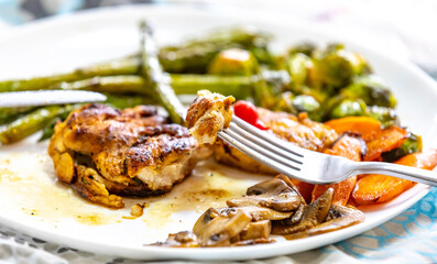 Real, strong, healthy, nutritious food, grilled chicken, pimenta biquinho, asparagus, mushrooms, Brussels sprouts and carrots.