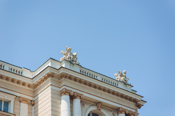 Fototapeta premium The facade and roof of the Opera and Ballet Theatre in Odessa. Sculptures of Glory, Orpheus, centaur, Terpsichore, Melpomene, panthers, mascarons and cupids. Architecture style of Viennese Baroque.