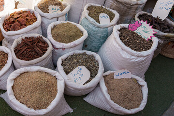 Colorful spices for sale in large quantities at a small city market