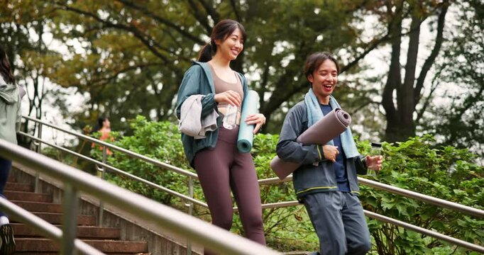 Japanese, people and steps walking for yoga outdoor, fitness ready and journey of mindfulness peace. Friends, talking and stairs with bottle of pilates morning, holistic healing and wellness in Japan