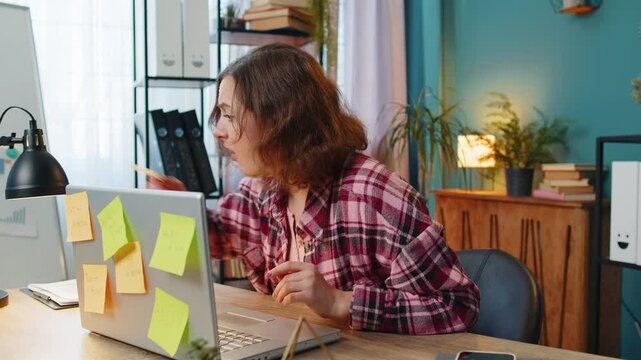 Tired exhausted fatigue young businesswoman office employee manager sits in office table with laptop sticky notes sticks with many tasks inscription help, feels sad boredom overworked multitasking.