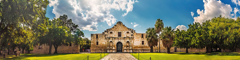 San Antonio Alamo: The iconic Alamo mission in San Antonio, surrounded by lush greenery and a crisp blue sky.