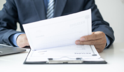 Executive CEO businessman checking job applicant documents resumes, interviews, and signing to approve the contract in the office room