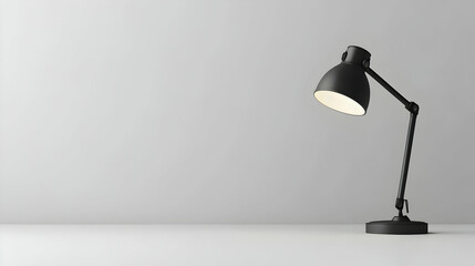 Minimalist black desk lamp on white background.