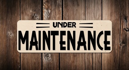 under maintenance lettering on card with wooden background