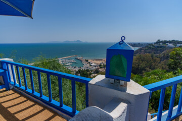 Beautiful view from the blue balcony to the distant sea and marina
