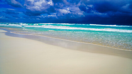 Stunning seascape of dark storm clouds over the aquamarine blue waters of the Caribbean sea on Playa Chacmool beach in downtown Cancun,in the prime Hotel Zone,Cancun,Quintana Roo,Mexico 