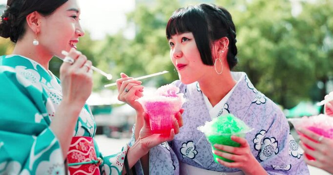 Women, outdoor and eating dessert at Japan festival with sharing slush drink, taste test and enjoyment in kimono. Traditional fashion, people and friends with kakigori ice for refreshment and culture