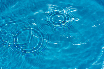 Blue water with ripples on the surface. Defocus blurred transparent blue colored clear calm water...