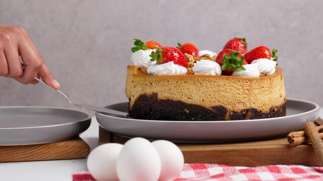 Mexican chocoflan, flan napolitano, a Mexican dessert with strawberries on top, Mexican woman places a slice of impossible cake on a plate