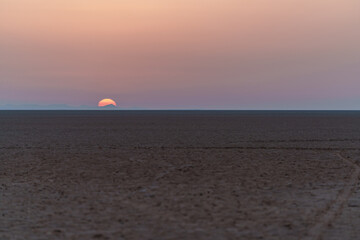 sunrise over a dry salt lake