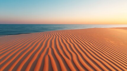 Naklejka premium Sunset Sandscapes: A mesmerizing view of a vast desert expanse, with sculpted sand dunes stretching towards a serene ocean horizon as the sun paints the sky in vibrant hues of orange and blue.