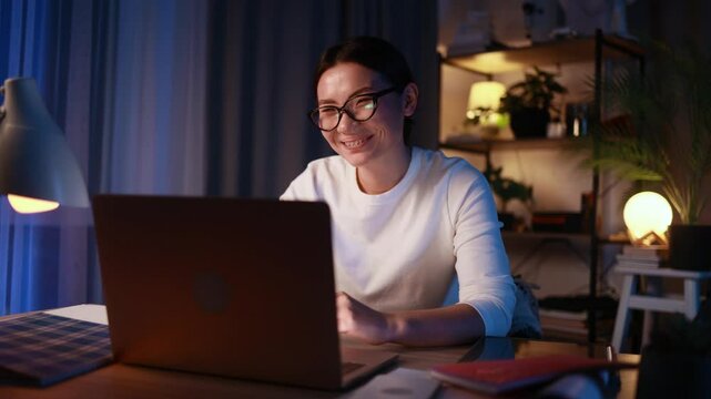 Beautiful young asian woman having video call conference meeting interview by computer at home Confident female talking on working conversation having distance remote job at late night indoors