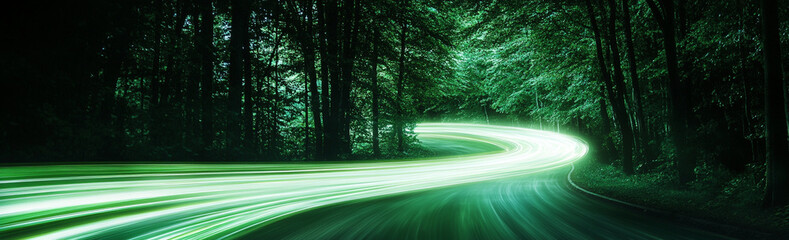mesmerizing scene of forest road illuminated by glowing green light trails, creating sense of motion and mystery in serene woodland environment
