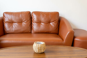 cozy interior of living room space with brown sofa, table