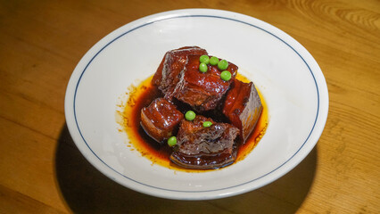Dongpo Pork, a famous Chinese dish, is a tender, flavorful braised pork belly, slow-cooked in a rich sauce made from soy sauce, Shaoxing wine, and sugar, named after the poet and gastronome Su Dongpo.