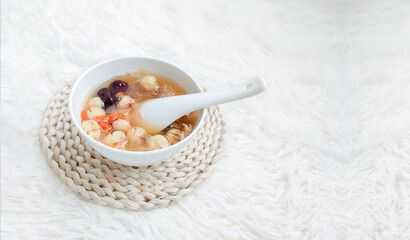 Silver Ear Lotus Seed Soup is a traditional Chinese dessert made with tremella fungus, lotus seeds, and rock sugar, known for its sweet taste, smooth texture, and health benefits.